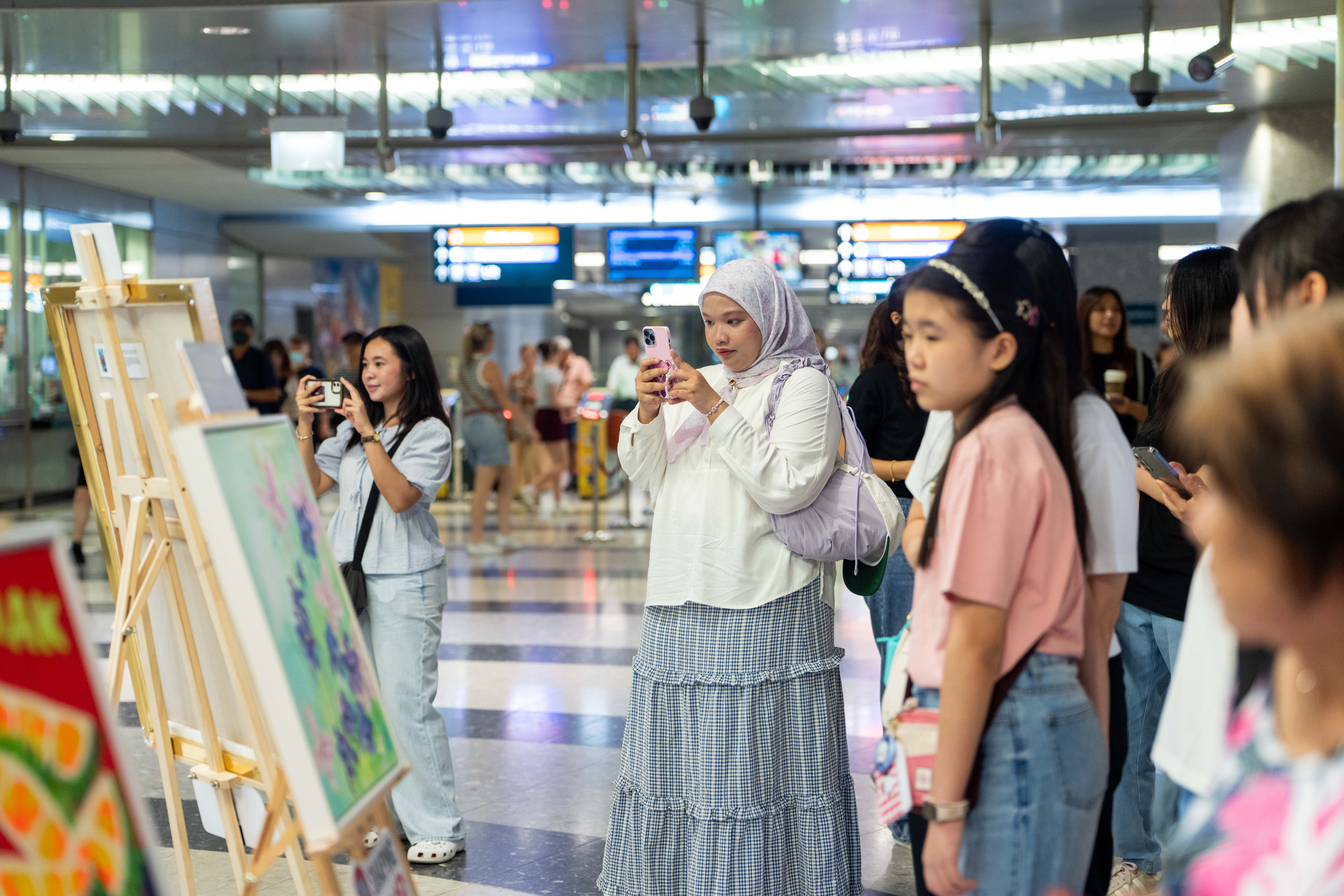 Audience members viewing and admiring the artwork.